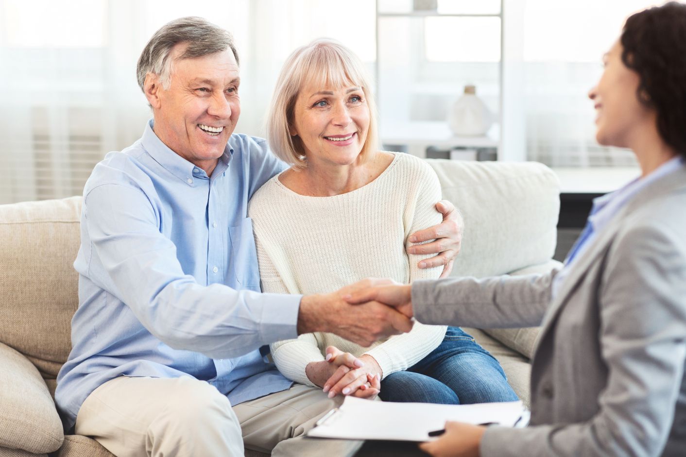 Hearing Aid Counseling and Fitting older couple at hearing aid fitting with audiologist